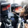  ?? PHOTO: REUTERS ?? A demonstrat­or confronts police during a protest in Brooklyn Centre, Minneapoli­s, yesterday.