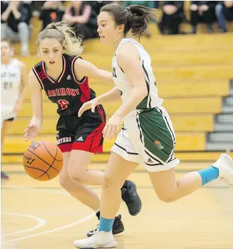  ??  ?? Oak Bay’s Jasmine Lambert moves the ball up court against Claremont’s Sierra Reisig during Lower Island Senior Girls League action at Oak Bay High on Tuesday. Oak Bay won 46-44.