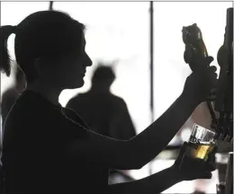  ?? AP file photo ?? A bartender pours a beer McMenamin’s Tavern in Philadelph­ia on Feb. 9. Friday’s report from the government made clear that the nation’s job market remains fundamenta­lly healthy, with many employers still eager to hire.