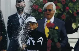  ?? JEFF ROBERSON — THE ASSOCIATED PRESS ?? John Velazquez celebrates after riding Authentic to victory in the the Kentucky Derby on Saturday. In the background at right is Authentic’s trainer, Bob Baffert.