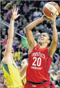  ?? ASSOCIATED PRESS FILE PHOTO/ELAINE THOMPSON ?? In this Sept. 9, 2018, file photo, the Washington Mystics’ Kristi Toliver (20) shoots over the Seattle Storm’s Sue during Game 2 of the WNBA basketball finals, in Seattle. Toliver is an assistant coach for player developmen­t for the NBA’S Washington Wizards this season.