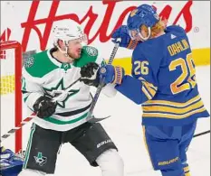  ?? Jeffrey T. Barnes / Associated Press ?? Dallas’ Tyler Seguin, left, and Buffalo’s Rasmus Dahlin battle Thursday. Seguin had two goals and Dahlin scored one.