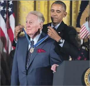  ?? Andrew Harnik Associated Press ?? PRESIDENT OBAMA presents Scully with the Presidenti­al Medal of Freedom at a White House ceremony on Nov. 22, 2016. Scully “turned contests into conversati­ons,” Obama said.