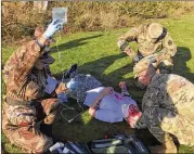  ?? PHOTOS BY ANDREW SELSKY / ASSOCIATED PRESS ?? Medics from both armies team up to practice first aid during the exercise. U.S. and Chinese forces have not collaborat­ed yet in an actual disaster response.