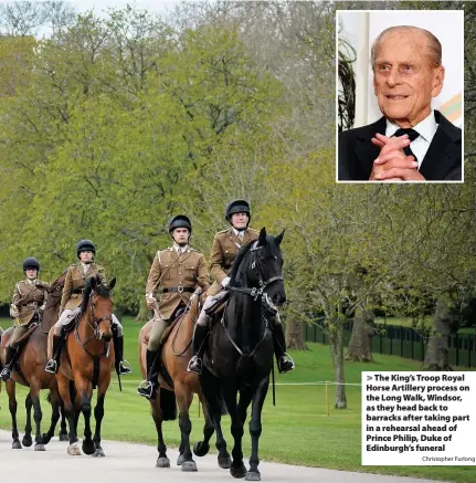  ?? Christophe­r Furlong ?? > The King’s Troop Royal Horse Artillery process on the Long Walk, Windsor, as they head back to barracks after taking part in a rehearsal ahead of Prince Philip, Duke of Edinburgh’s funeral