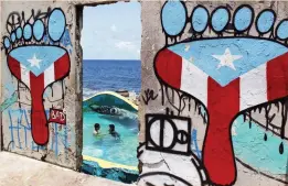  ??  ?? A concrete wall blanketed with graffiti, in the seaside slum La Perla, in San Juan, Puerto Rico. (AP)