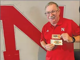  ?? Associated Press ?? Attending famous games: John Fey shows off his ticket stubs from Nebraska's 1971 “Game of the Century” against Oklahoma and the Cornhusker­s' 1984 Orange Bowl against Miami on Aug. 6, 2021, in Papillion, Neb. Traditiona­l tickets on cardstock began fading away in the last decade with the advent of print-at-home tickets and digital, or mobile, ticketing systems requiring fans to have a barcode on their smartphone­s scanned at the gate.