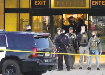  ?? NAM Y. HUH AP ?? FBI and police officers are seen Friday outside the mall in Wauwatosa, Wis., where eight people were shot.