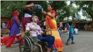  ?? — PTI ?? A patient on a wheelchair attended to by his relatives outside the LNJP Hospital in New Delhi on Monday.