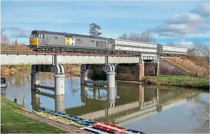  ?? STEPHEN TUCKER ?? Hanson & Hall ‘Hoover’ No. 50008 Thunderer has been used on some recent stock moves, and in connection with these is pictured crossing the River Avon at Fladbury (Worcesters­hire) hauling two translator vehicles as the 6Z50/12.44 Honeybourn­e Sidings to Kings Norton On Track Plant Dept on February 11.