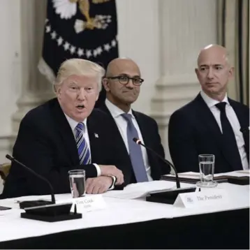  ?? OLIVIER DOULIERY/ABACA PRESS/TRIBUNE NEW SERVICE ?? U.S. President Donald Trump unloaded again on Amazon.com, whose CEO is Jeff Bezos, right, in a tweet Wednesday.