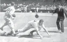  ?? COURTESY OF MARY SARTY VIA AP ?? This 1945 photo shows Boston Red Sox pitcher Pinky Woods falling to the ground while running the bases during a game against the White Sox.