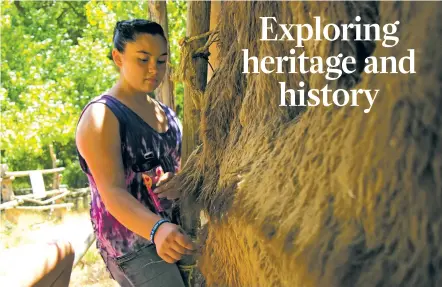  ??  ?? Faith Anderson, 12, studies animal hides at a historical booth at El Rancho de las Golondrina­s.