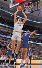  ?? MICHAEL REAVES/GETTY IMAGES ?? Purdue’s 7-4 superstar center, Zach Edey (30 points, 13 rebounds), shoots over Penn State forward Kebba Njie on Sunday.