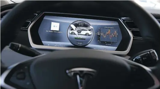  ?? JUSTIN SULLIVAN/ GETTY IMAGES FILES ?? The new Tesla Model S car features a large tablet computer on its dashboard that not only displays informatio­n about the vehicle, but also displays a jumbo- sized version of Google Maps to assist the driver with navigation . The number of cars...