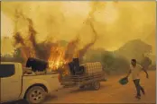  ?? ANDRE PENNER — THE ASSOCIATED PRESS ?? Volunteer Divino Humberto tries to douse a fire along a dirt road off the Trans-Pantanal highway in the Pantanal wetlands near Pocone, Mato Grosso state, Brazil, on Sept. 11.