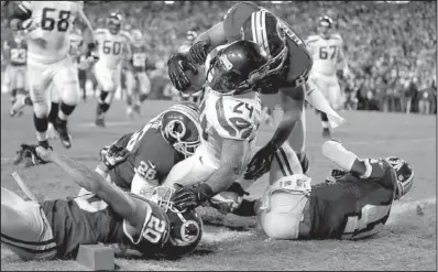  ?? AP/MATT SLOCUM ?? Seattle Seahawks running back Marshawn Lynch (24) tumbles into the end zone for a touchdown during the second half of Sunday’s wildcard playoff game against the Washington Redskins in Landover, Md. Lynch finished with 132 yards on 20 carries as the...