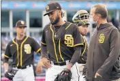  ?? SUE OGROCKI — THE ASSOCIATED PRESS ?? Padres shortstop Fernando Tatis Jr., center, leaves the field following an injury in the third inning of Tuesday’s game.