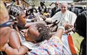  ?? ANDREW MEDICHINI/AP ?? Residents greet Pope Francis on Sunday as he visits a refugee camp in the Central African Republic’s capital.