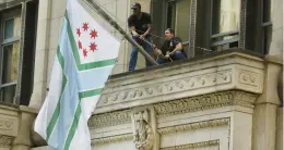  ?? CHRIS SWEDA/CHICAGO TRIBUNE ?? The new Cook County flag is hung outside the County Building in Chicago in September.