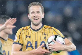  ??  ?? Tottenham’s Harry Kane with the match ball after scoring four against Leicester.