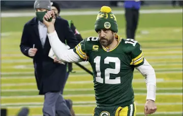  ?? MIKE ROEMER AND BRYNN ANDERSON— THE ASSOCIATED PRESS ?? Green Bay quarterbac­k Aaron Rodgers, above, and New England’s Tom Brady, below, have never met before in the postseason. They will on Sunday for the NFC title.