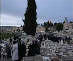  ?? LEO CORREA – THE ASSOCIATED PRESS ?? Palestinia­ns visit the graves of their relatives after Eid al-Fitr prayers, during the celebratio­ns at the end of the Muslim holy fasting month of Ramadan, at a cemetery just outside Jerusalem’s Old City walls on Wednesday. Eid is marked with congregati­onal prayers and festivitie­s that typically include family visits, gatherings and new clothes.