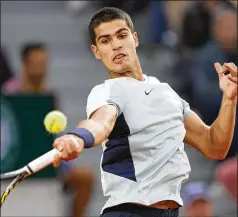  ?? JEAN-FRANCOIS BADIAS/ASSOCIATED PRESS ?? Spain’s Carlos Alcaraz plays a shot against countryman Albert Ramosvinol­as during their second-round match at the French Open. The next opponent for Alcaraz is Sebastian Korda — the only man to defeat him on clay this year.