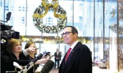  ?? — AP ?? NEW YORK: Former Goldman Sachs executive Steven Mnuchin, US PresidentE­lect Donald Trump’s nominee for Treasury Secretary, speaks with reporters in the lobby of Trump Tower yesterday.