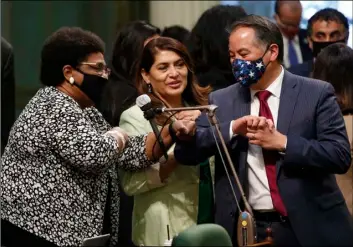  ?? AP Photo/Rich Pedroncell­i ?? In this June 10 file photo, Assemblywo­man Shirley Weber, D-San Diego (left) receives congratula­tions from fellow Assembly members Sharon Quirk-Silva, D-Fullerton (center) and Phil Ting, D-San Francisco, after the Assembly approved her measure to place a constituti­onal amendment on the ballot to let voters decide if the state should overturn its ban on affirmativ­e action programs, at the Capitol in Sacramento, Calif.