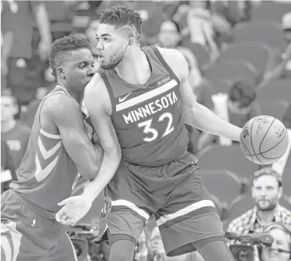  ?? Yi-Chin Lee / Houston Chronicle ?? Rockets center Clint Capela, left, held his own this season against Minnesota’s Karl-Anthony Towns. Capela’s 18.8 points per game average against the Timberwolv­es was the second highest on the Rockets, trailing only James Harden.