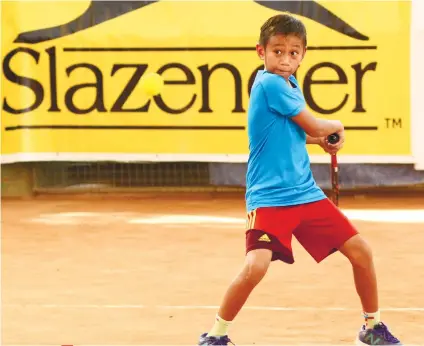  ?? SUNSTAR FOTO / ALLAN DEFENSOR ?? SMALL BUT STRONG. Chad Connor Cuizon (above) beats Francis Plopenio in their Boys 12 match of the Palawan Pawnshop Tennis at the Citigreen courts.