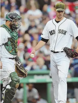  ?? STAFF PHOTO BY NANCY LANE ?? ROUGH DAY: Starter Rick Porcello talks with catcher Sandy Leon during yesterday’s loss to the Mariners at Fenway.