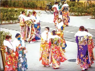  ?? AFP ?? Twenty-year-old women dressed in kimonos gather outside Todoroki Arena during the ‘Coming-of-Age Day’ celebratio­n ceremony in Kawasaki, Kanagawa prefecture, on Monday.