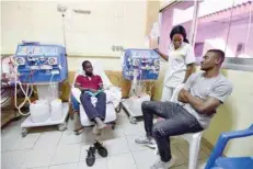  ?? — AFP ?? Ivorian football player Salomon Kalou (right) speaks with a boy suffering from a kidney failure, during a dialysis session in a hospital in Adjame, on December 26, 2017.