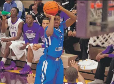  ?? | CHARLES MITCHELL/FOR THE POST-TRIBUNE ?? Lake Central’s Tye Wilburn shoots over Merrillvil­le’s Jairus Stevens during their game in December at Merrillvil­le High School.