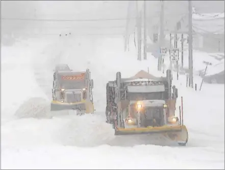  ?? PETE BANNAN – DIGITAL FIRST MEDIA ?? PennDOT-contracted plow trucks clear snow along Lancaster Avenue in Devon Tuesday morning. Most people stayed off the road during the morning, easing work for plows.