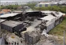  ?? TATAN SYUFLANA - THE ASSOCIATED PRESS ?? The damage of a fireworks factory is seen as police investigat­ors inspect the site of an explosion and fire in Tangerang, on the outskirts of Jakarta, Indonesia, Friday. Investigat­ors were trying to determine the cause of the fire that killed dozens of...