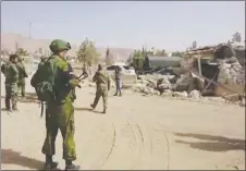  ?? AP PHOTO ?? Syrian government forces and Russian soldiers oversee the evacuation by buses of rebel fighters and their families at a checkpoint in eastern Gouta, Syria.