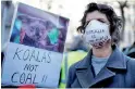  ?? Reuters ?? A protester wearing a mask, attends a demonstrat­ion against the Australian government's inaction over climate change despite the bushfires crisis, outside the Australian Embassy in London.