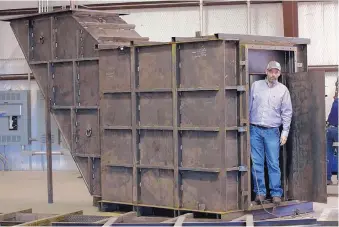  ?? JOYCE MARSHALL/FORT WORTH STAR TELEGRAM ?? Gary Lynch, the general manager of Rising S Company, a small rural factory where bomb shelters are made, stands in the doorway of a bunker under constructi­on. Bomb shelter orders are up 700 percent.