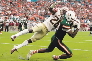  ?? Lynne Sladky / Associated Press ?? Miami wide receiver Lawrence Cager scores past Florida State defensive back Asante Samuel Jr.