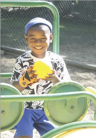  ?? Brodie Johnson • Times-Herald ?? Roderick Hamilton Jr., 4, sits on a piece of playground equipment while playing with his ball. Children in local daycare centers are enjoying the sunshine and mild temperatur­es.