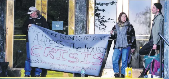  ?? — NICK PROCAYLO ?? Organizers from the Our Homes Can’t Wait Coalition blockaded the entrances to Vancouver City Hall Tuesday morning in an effort to shut down operations, forcing council to hold an impromptu meeting in a garden near the property.