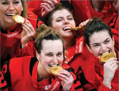  ?? GABRIEL BOUYS / AFP ?? Gold medalists Canada celebrate during the victory ceremony of the women’s ice hockey competitio­n at the Wukesong Sports Centre on Feb 17. Team captain Marie-Philip Poulin is at lower left.