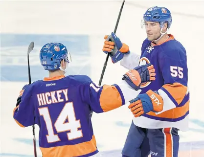  ??  ?? The Islanders’ Johnny Boychuk, right, celebrates scoring in the third period with Thomas Hickey.