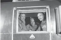  ?? Associated Press, File ?? ■ Apollo 11 crew members, from left, Neil Armstrong, Buzz Aldrin and Michael Collins sit inside a quarantine van July 27, 1969, in Houston.