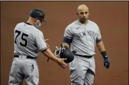  ?? CHRIS O’MEARA - THE ASSOCIATED PRESS ?? New York Yankees’ Rougned Odor, right, hands his helmet to first base coach Reggie Willits after popping out against the Tampa Bay Rays during the second inning of a baseball game Sunday, April 11, 2021, in St. Petersburg, Fla.