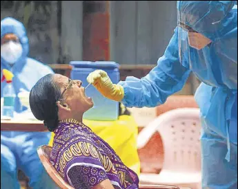  ??  ?? A doctor takes a swab sample of a Dharavi resident during a Covid-19 testing drive on Saturday. There have been 2,20,112 tests conducted across Mumbai till Friday. SATISH BATE/HT PHOTO