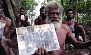  ?? (Reuters) ?? IKUNALA VILLAGE Chief Yapa holds photos of himself and four other local men with Britain’s Prince Philip, taken during their 2007 trip to England, as he sends their condolence­s after the prince passed away at age 99 on Friday, in Ikunala, Tanna Island, Vanuatu yesterday.